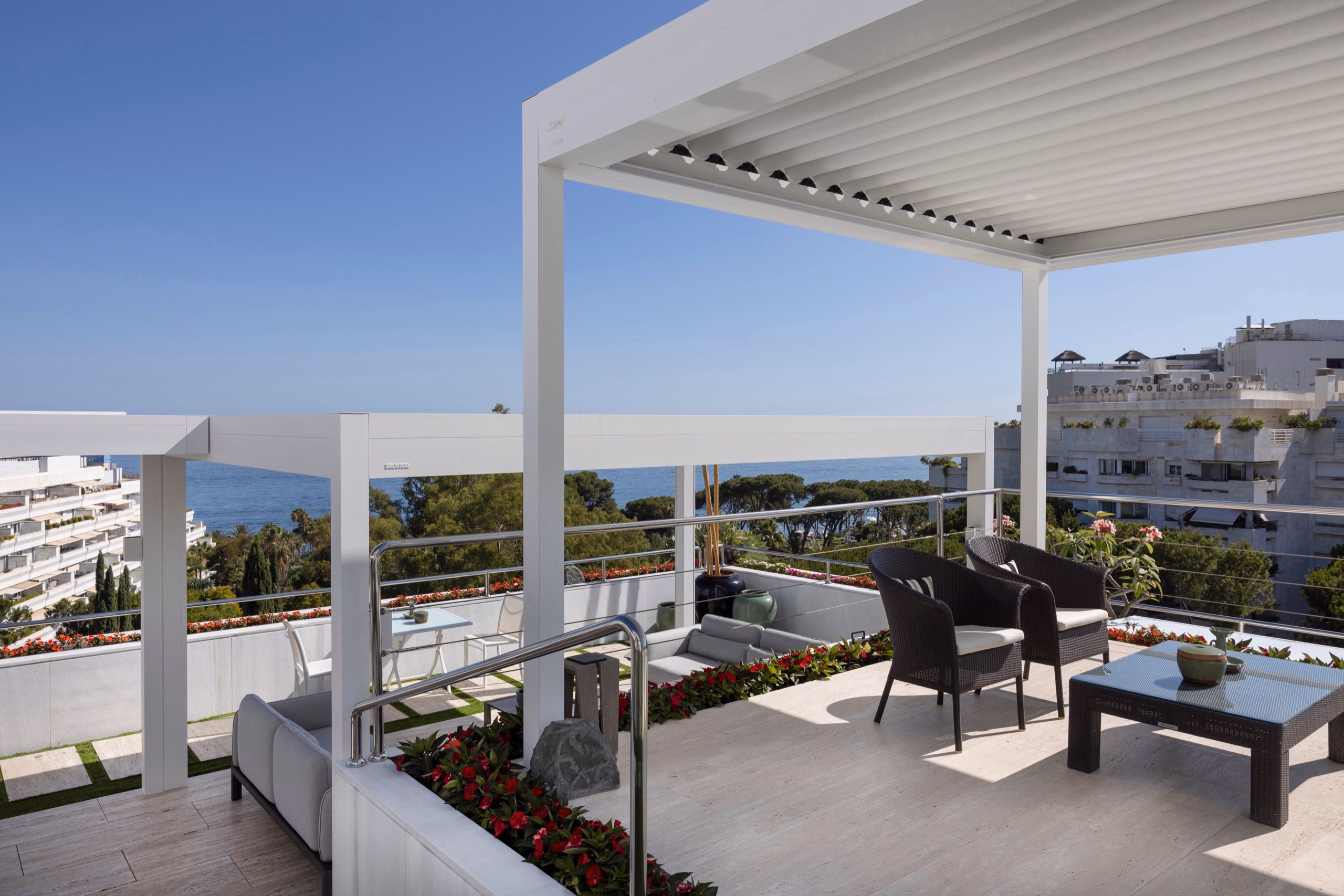 B600S pergola with white structure framing panoramic coastal views